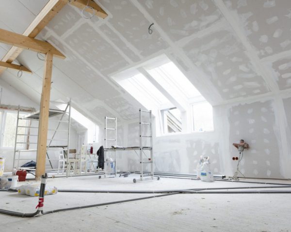 Attic finishing construction site in the phase drywall spackling and plastering before screeding