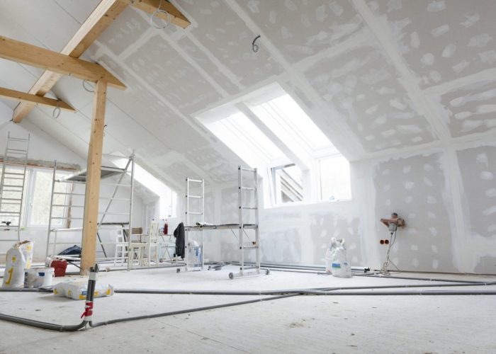 Attic finishing construction site in the phase drywall spackling and plastering before screeding